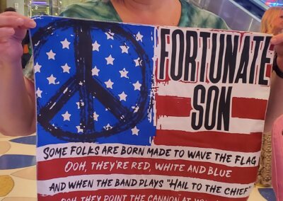 Holly Deaney at the Hard Rock Hotel and Casino at the John Fogerty concert with the Fortunate Son banner.