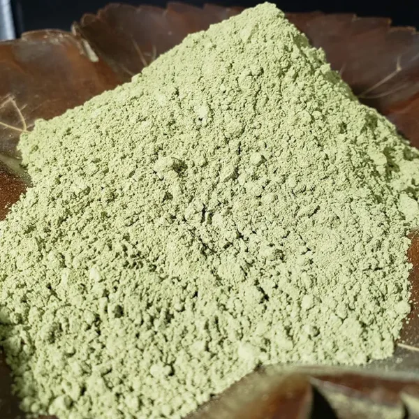Organic Green Kratom Powder showcased in a rustic wooden leaf stand.