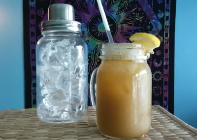 kava in a mason jar with a straw
