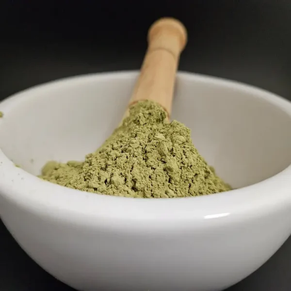 Green Mahakam kratom powder 152902 in apothecary bowl.
