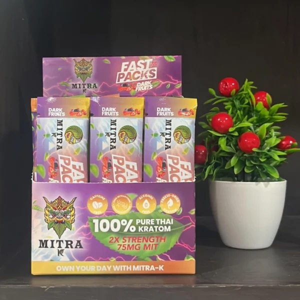 A display of Mitra K Fast Packs in Dark Fruit flavor, neatly arranged to showcase their attractive design and kratom convenience.